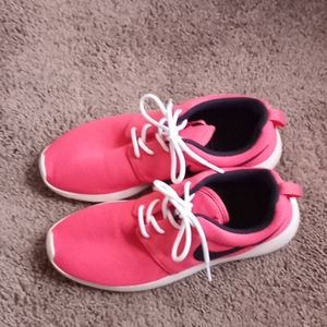 Woman's pink and black Nikes